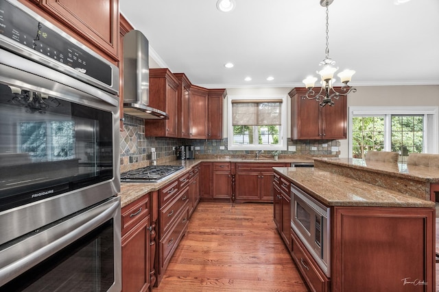 4037 Main St, Downers Grove, IL 60515 - kitchen with wall chimney exhaust hood, appliances with stainless steel finishes, a chandelier, healthy amount of natural light, and crown molding