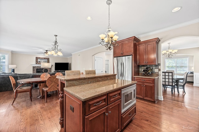 4037 Main St, Downers Grove, IL 60515 - kitchen with appliances with stainless steel finishes, a chandelier, arched walkways, healthy amount of natural light, and ornamental molding