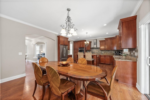 4037 Main St, Downers Grove, IL 60515 - dining space with a chandelier, arched walkways, light wood-type flooring, ornamental molding, and recessed lighting