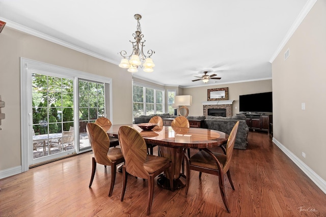 4037 Main St, Downers Grove, IL 60515 - dining room with a brick fireplace, crown molding, a ceiling fan, wood finished floors, and a chandelier