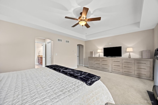 4037 Main St, Downers Grove, IL 60515 - bedroom featuring arched walkways, a tray ceiling, light colored carpet, and ceiling fan