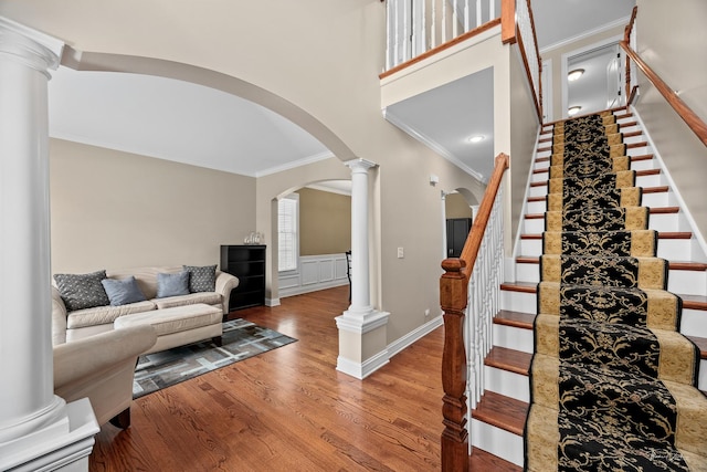 4037 Main St, Downers Grove, IL 60515 - stairway featuring arched walkways, ornamental molding, wood finished floors, ornate columns, and a towering ceiling