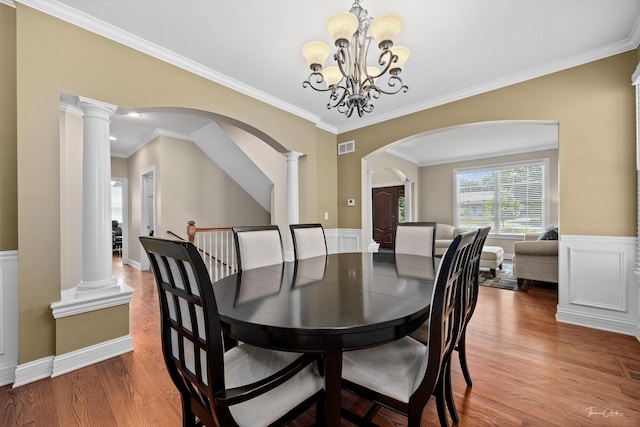 4037 Main St, Downers Grove, IL 60515 - dining space with arched walkways, wood finished floors, a chandelier, ornamental molding, and decorative columns