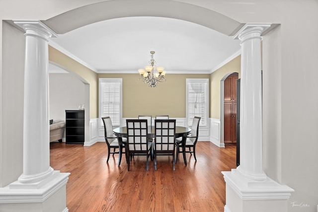 4037 Main St, Downers Grove, IL 60515 - dining room featuring decorative columns, arched walkways, plenty of natural light, crown molding, and a decorative wall