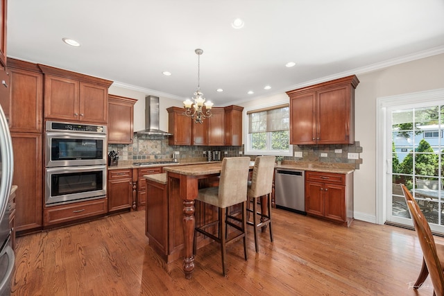 4037 Main St, Downers Grove, IL 60515 - kitchen featuring wall chimney exhaust hood, stainless steel appliances, a chandelier, plenty of natural light, and crown molding