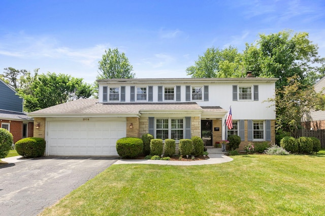 1014 Indian Rd, Glenview, IL 60025 - traditional-style home with driveway, a garage, a front lawn, stone siding, and a chimney