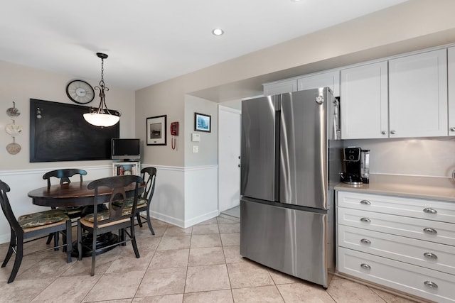1014 Indian Rd, Glenview, IL 60025 - kitchen featuring freestanding refrigerator, white cabinets, light countertops, pendant lighting, and light tile patterned floors