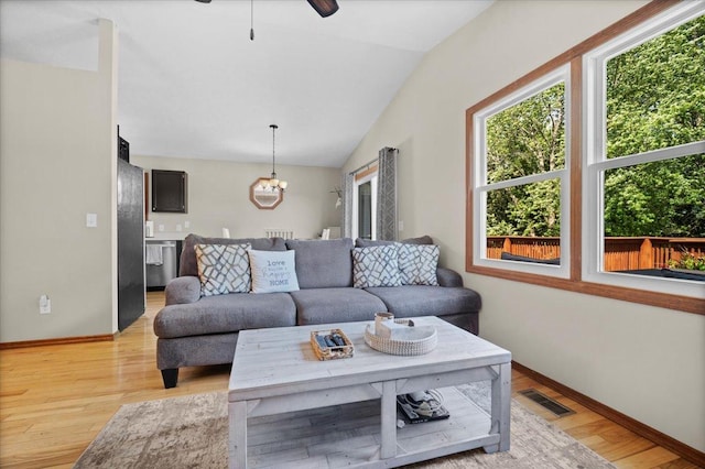 16 Rutherford Ct, Bloomington, IL 61705 - living room featuring a chandelier, lofted ceiling, light wood-style flooring, and ceiling fan