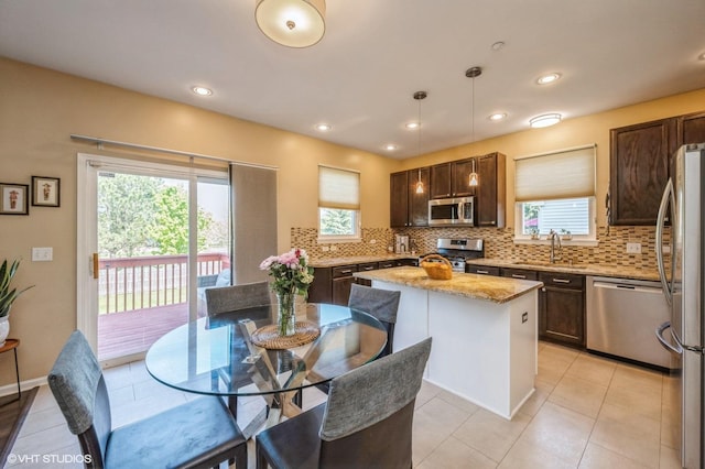 2140 Colchester Ct, Hoffman Estates, IL 60192 - kitchen featuring appliances with stainless steel finishes, tasteful backsplash, dark brown cabinetry, healthy amount of natural light, and recessed lighting