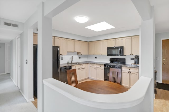 59 S Hale St Unit 402, Palatine, IL 60067 - kitchen with black appliances, light brown cabinetry, a skylight, a peninsula, and light wood-style flooring