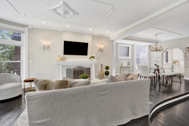 435 W Roslyn Pl Unit 2E, Chicago, IL 60614 - living room with arched walkways, a fireplace, a chandelier, dark wood finished floors, and ornamental molding