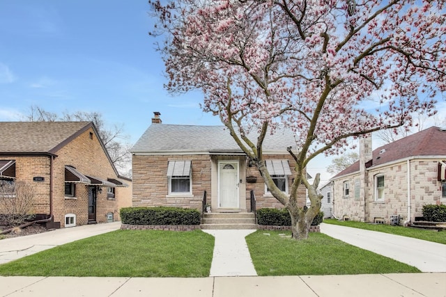 4445 Grove Ave, Stickney, IL 60402 - view of front facade with a front yard, a chimney, and stone siding