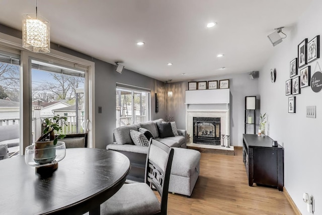4445 Grove Ave, Stickney, IL 60402 - living area with recessed lighting, a glass covered fireplace, light wood-style flooring, and a chandelier