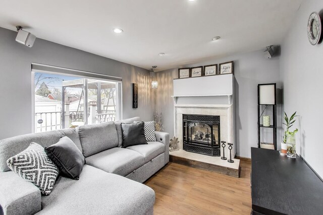 4445 Grove Ave, Stickney, IL 60402 - living room with wood finished floors, recessed lighting, and a glass covered fireplace