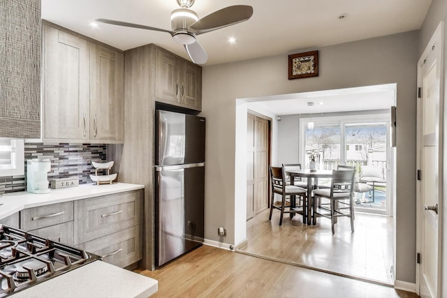 4445 Grove Ave, Stickney, IL 60402 - kitchen featuring freestanding refrigerator, light wood-type flooring, a ceiling fan, light countertops, and stovetop