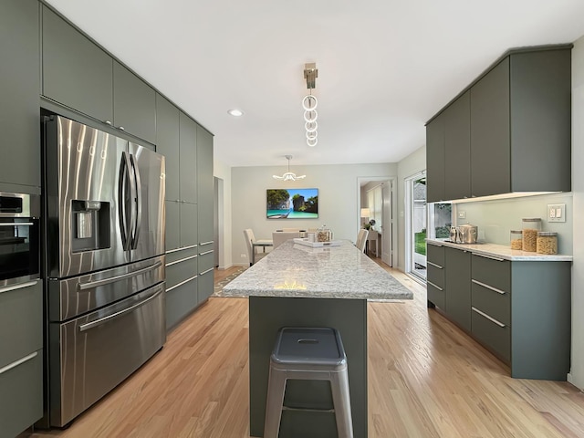 389 Forest Ave, Glen Ellyn, IL 60137 - kitchen with stainless steel appliances, a center island, light wood-style floors, hanging light fixtures, and recessed lighting