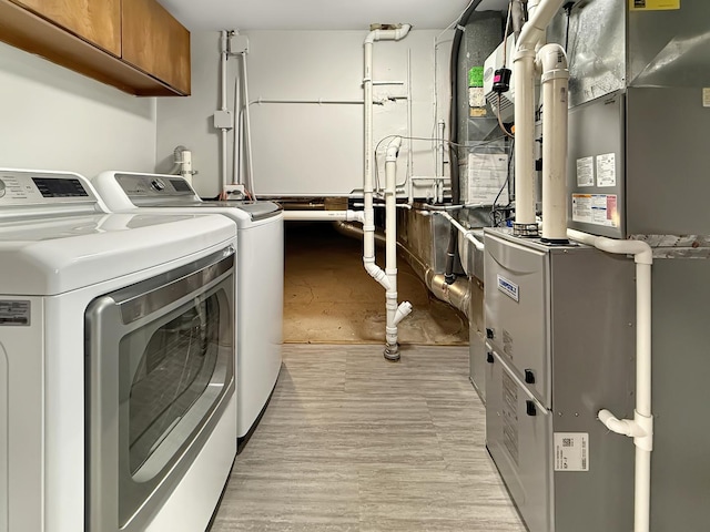 389 Forest Ave, Glen Ellyn, IL 60137 - washroom with independent washer and dryer, cabinet space, heating unit, and light wood finished floors