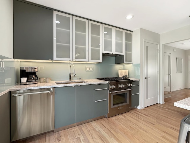 389 Forest Ave, Glen Ellyn, IL 60137 - kitchen featuring appliances with stainless steel finishes, light wood-style flooring, gray cabinets, recessed lighting, and glass insert cabinets