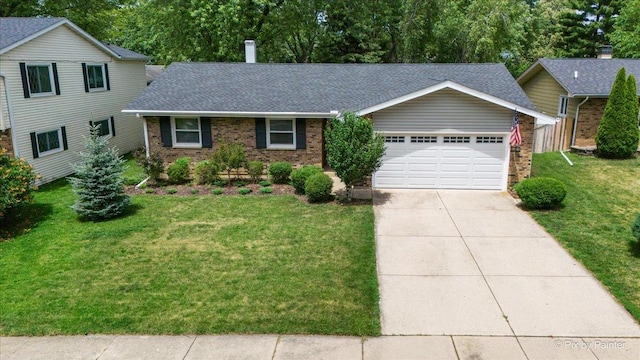 862 Arthur Dr, Elgin, IL 60120 - view of front of property with brick siding, a garage, a front lawn, and concrete driveway