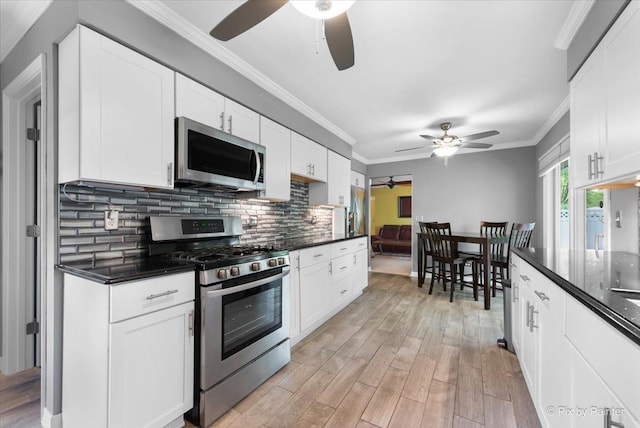 862 Arthur Dr, Elgin, IL 60120 - kitchen with stainless steel appliances, a ceiling fan, light wood-style floors, tasteful backsplash, and crown molding