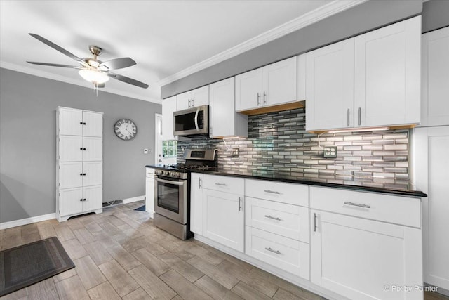 862 Arthur Dr, Elgin, IL 60120 - kitchen with appliances with stainless steel finishes, ceiling fan, dark countertops, decorative backsplash, and white cabinets