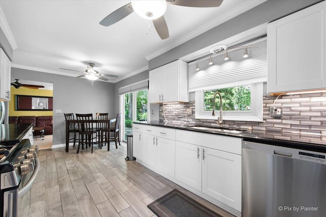 862 Arthur Dr, Elgin, IL 60120 - kitchen with stainless steel appliances, a ceiling fan, dark countertops, decorative backsplash, and ornamental molding