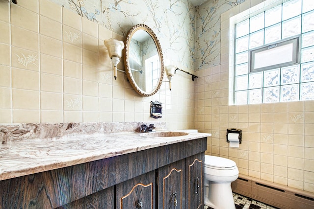 3124 N 77th Ct, Elmwood Park, IL 60707 - bathroom with baseboard heating, tile walls, vanity, healthy amount of natural light, and decorative backsplash