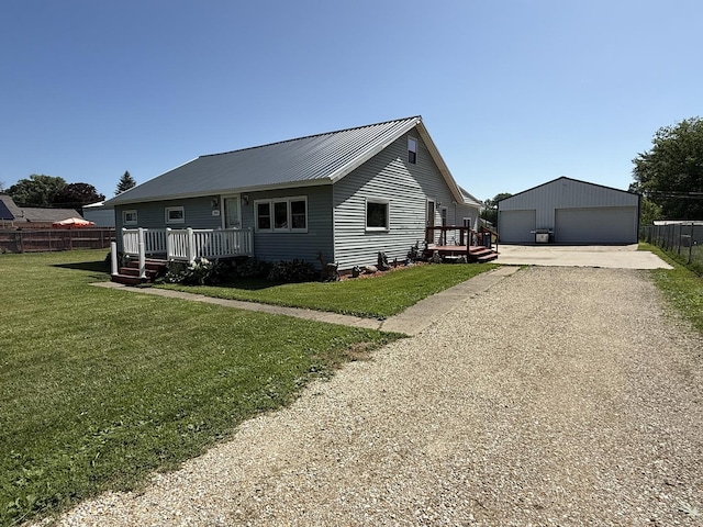 2705 Pine St, Rock Falls, IL 61071 - view of front of home with a detached garage, an outdoor structure, a metal roof, and a deck