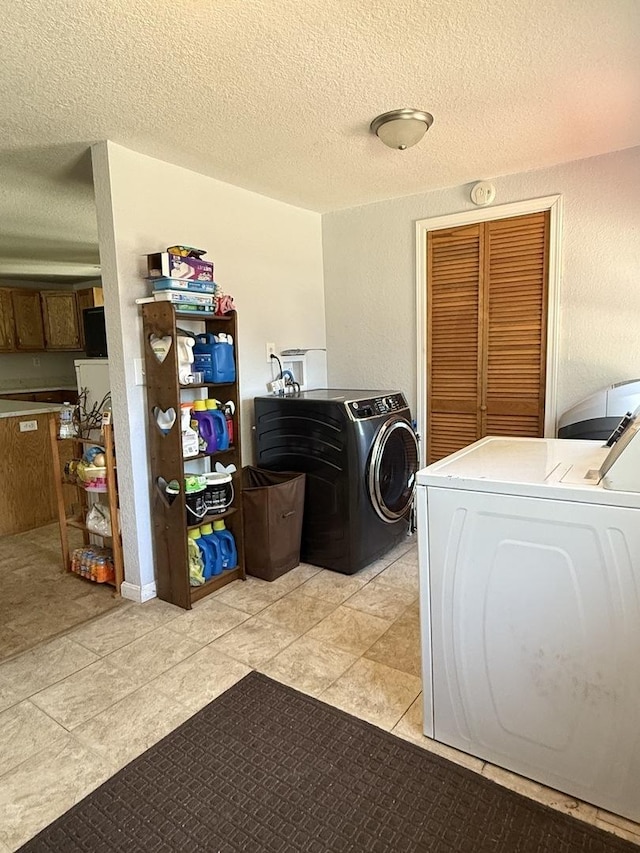 2705 Pine St, Rock Falls, IL 61071 - washroom with separate washer and dryer, a textured ceiling, and light tile patterned flooring