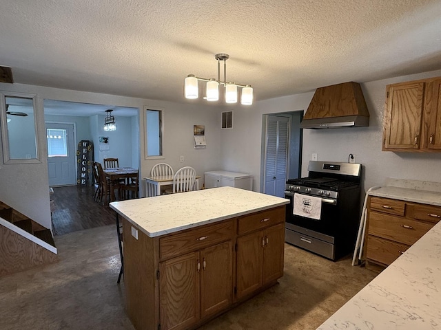 2705 Pine St, Rock Falls, IL 61071 - kitchen with gas range, custom exhaust hood, a textured ceiling, a kitchen island, and pendant lighting