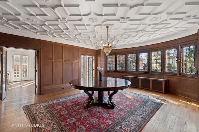 1120 Forest Ave, Evanston, IL 60202 - dining space featuring light wood-style flooring, a chandelier, and wooden walls