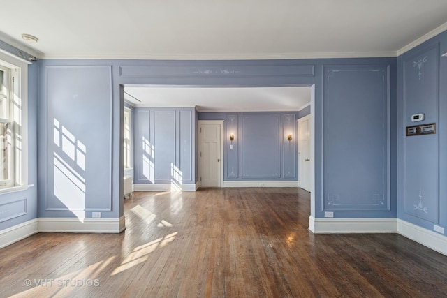 1120 Forest Ave, Evanston, IL 60202 - empty room featuring a decorative wall, dark wood-style flooring, crown molding, and a smoke detector