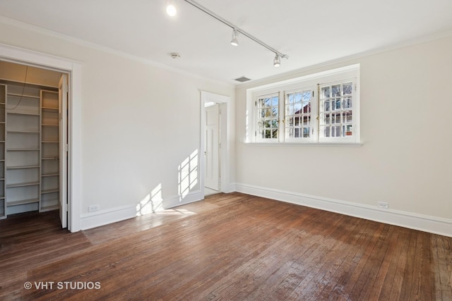 1120 Forest Ave, Evanston, IL 60202 - unfurnished bedroom featuring a spacious closet, track lighting, wood-type flooring, a closet, and ornamental molding