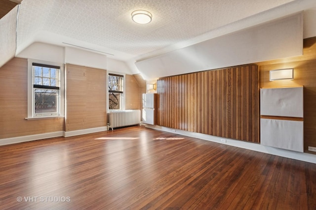 1120 Forest Ave, Evanston, IL 60202 - additional living space with radiator heating unit, hardwood / wood-style floors, lofted ceiling, and healthy amount of natural light