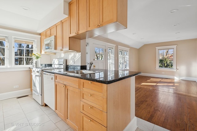 1120 Forest Ave, Evanston, IL 60202 - kitchen with white appliances, lofted ceiling, dark stone counters, a peninsula, and open floor plan