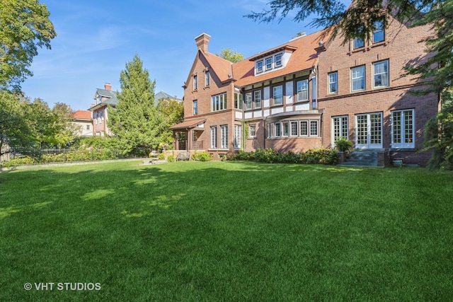1120 Forest Ave, Evanston, IL 60202 - back of property featuring a yard, brick siding, and a chimney