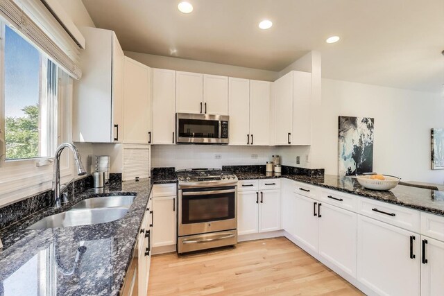 1728 W Terra Cotta Pl Unit D, Chicago, IL 60614 - kitchen featuring stainless steel appliances, white cabinetry, dark stone counters, and recessed lighting