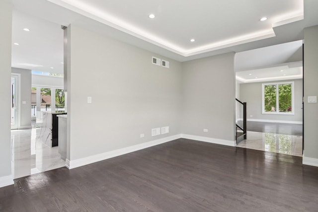 3933 Gloria Ct, Glenview, IL 60025 - unfurnished living room with stairway, wood finished floors, plenty of natural light, recessed lighting, and a tray ceiling