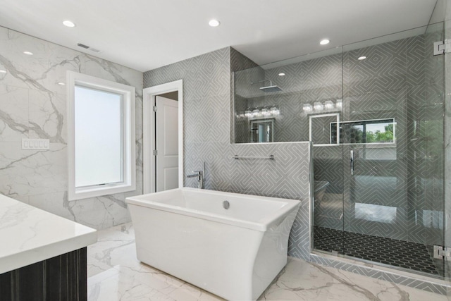 3933 Gloria Ct, Glenview, IL 60025 - bathroom with marble tiled floors, vanity, a freestanding bath, recessed lighting, and a shower stall