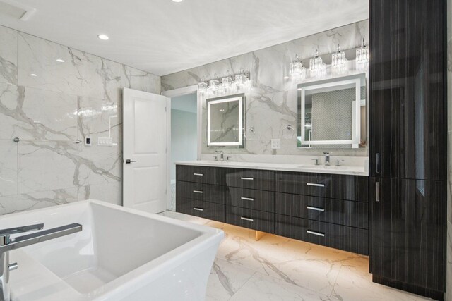 3933 Gloria Ct, Glenview, IL 60025 - bathroom featuring marble tiled flooring, a freestanding bath, double vanity, tile walls, and recessed lighting