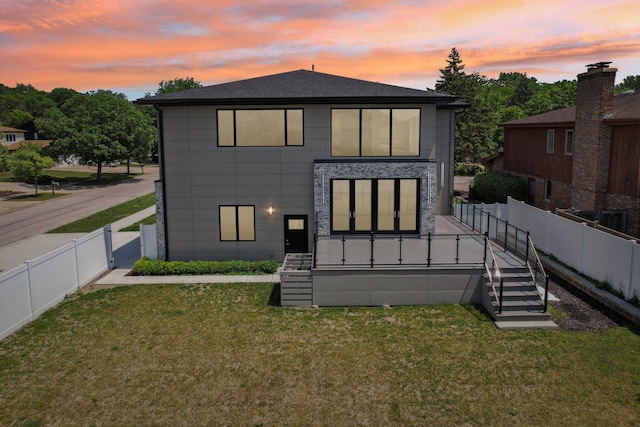 3933 Gloria Ct, Glenview, IL 60025 - back of property at dusk featuring a fenced backyard, stairs, a gate, and a shingled roof