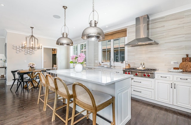 26 S Chestnut Ave, Arlington Heights, IL 60005 - kitchen featuring wall chimney range hood, stainless steel gas cooktop, a center island, decorative backsplash, and white cabinetry