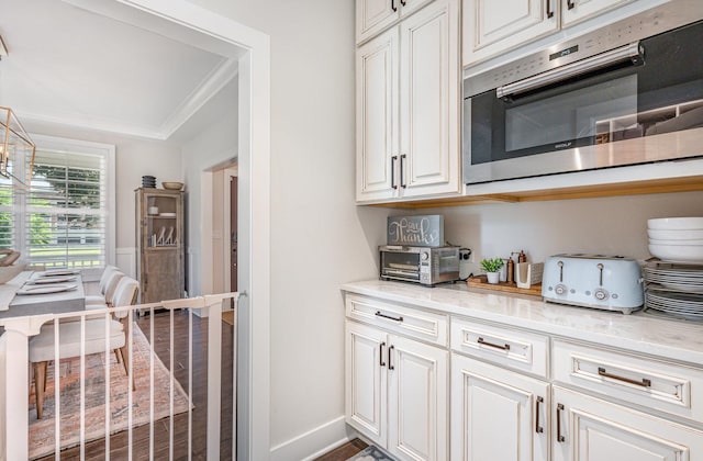 26 S Chestnut Ave, Arlington Heights, IL 60005 - kitchen with light stone counters, dark wood finished floors, ornamental molding, and white cabinets
