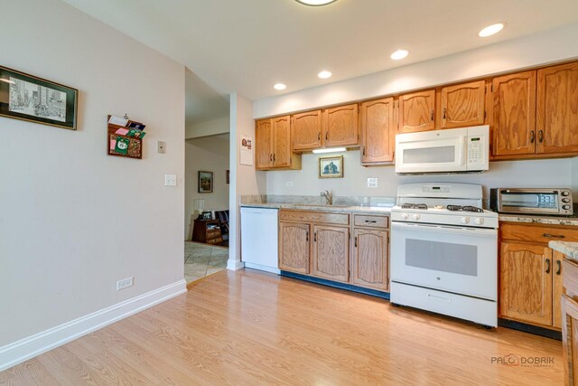 211 Winding Oak Ln, Buffalo Grove, IL 60089 - kitchen featuring white appliances, light wood-style flooring, light countertops, recessed lighting, and brown cabinets