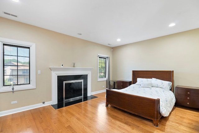4146 Cardinal Ct, Northbrook, IL 60062 - bedroom with light wood-type flooring, a fireplace with flush hearth, and recessed lighting