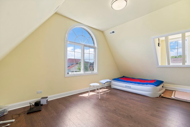 4146 Cardinal Ct, Northbrook, IL 60062 - unfurnished bedroom with lofted ceiling, multiple windows, and wood finished floors