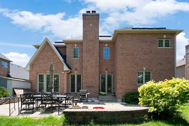 4146 Cardinal Ct, Northbrook, IL 60062 - rear view of house with a patio area, a chimney, brick siding, and entry steps