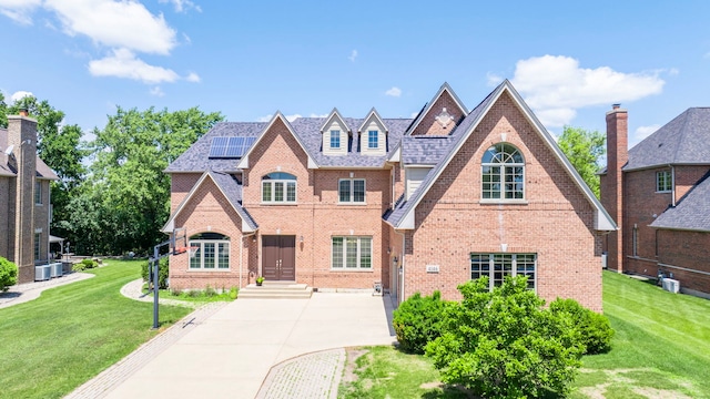 4146 Cardinal Ct, Northbrook, IL 60062 - view of front of house with brick siding, solar panels, and a front yard