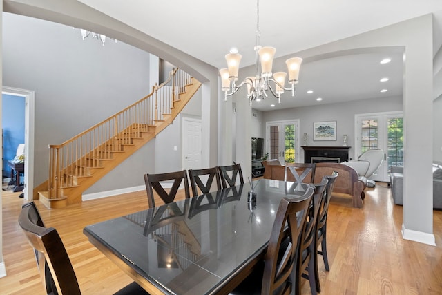4146 Cardinal Ct, Northbrook, IL 60062 - dining space with a chandelier, wood finished floors, stairway, arched walkways, and recessed lighting