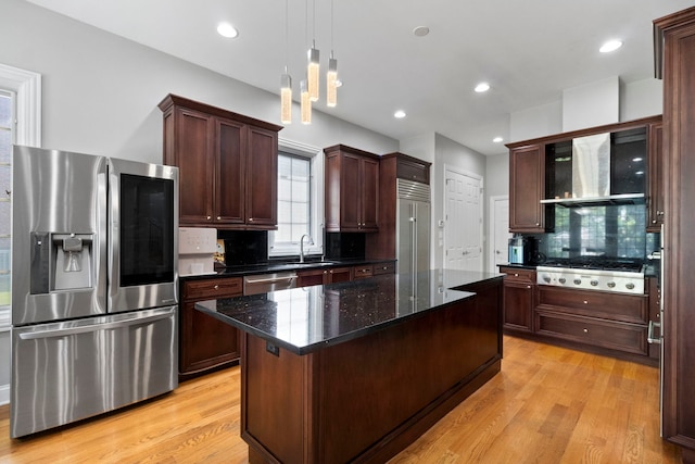 4146 Cardinal Ct, Northbrook, IL 60062 - kitchen with appliances with stainless steel finishes, wall chimney range hood, light wood-style floors, backsplash, and recessed lighting